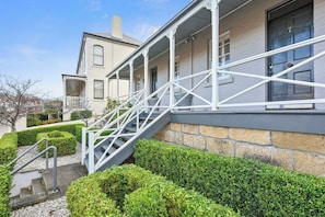 Stroll up to the covered porch, supported by white columns, and enjoy the serene surroundings.