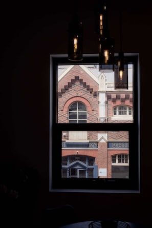 Stunning view of the historic building's arched window and brick facade.