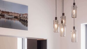 A modern dining area with a round table, black chairs, and a black bookshelf. - 3 Bedroom, Spacious Inner-City Pad (Hobart)