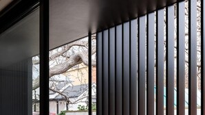 A modern interior with a sliding glass door leading to an outdoor area. - The Conservatory Summ (Hobart)