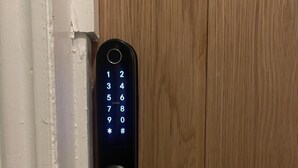 A modern door with a numeric keypad lock. - Family Friendly One Bedroom Apartment w King Bed (Colchester)