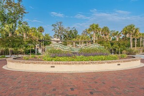 A landscaped area with a sign reading "Adventure Playground" and "Hilton Head Island 2020".