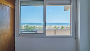 A window with a view of a beach and ocean. - Casa Clementina - One Bedroom Apartment, Sleeps 4 (Rimini)