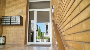 A brick exterior wall with a mailbox and a door leading to a balcony. - Casa Mavia - Two Bedroom Apartment, Sleeps 4 (Rivabella)