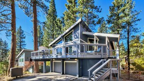 A modern two-story house with a balcony, garage, and a staircase leading to the upper level.