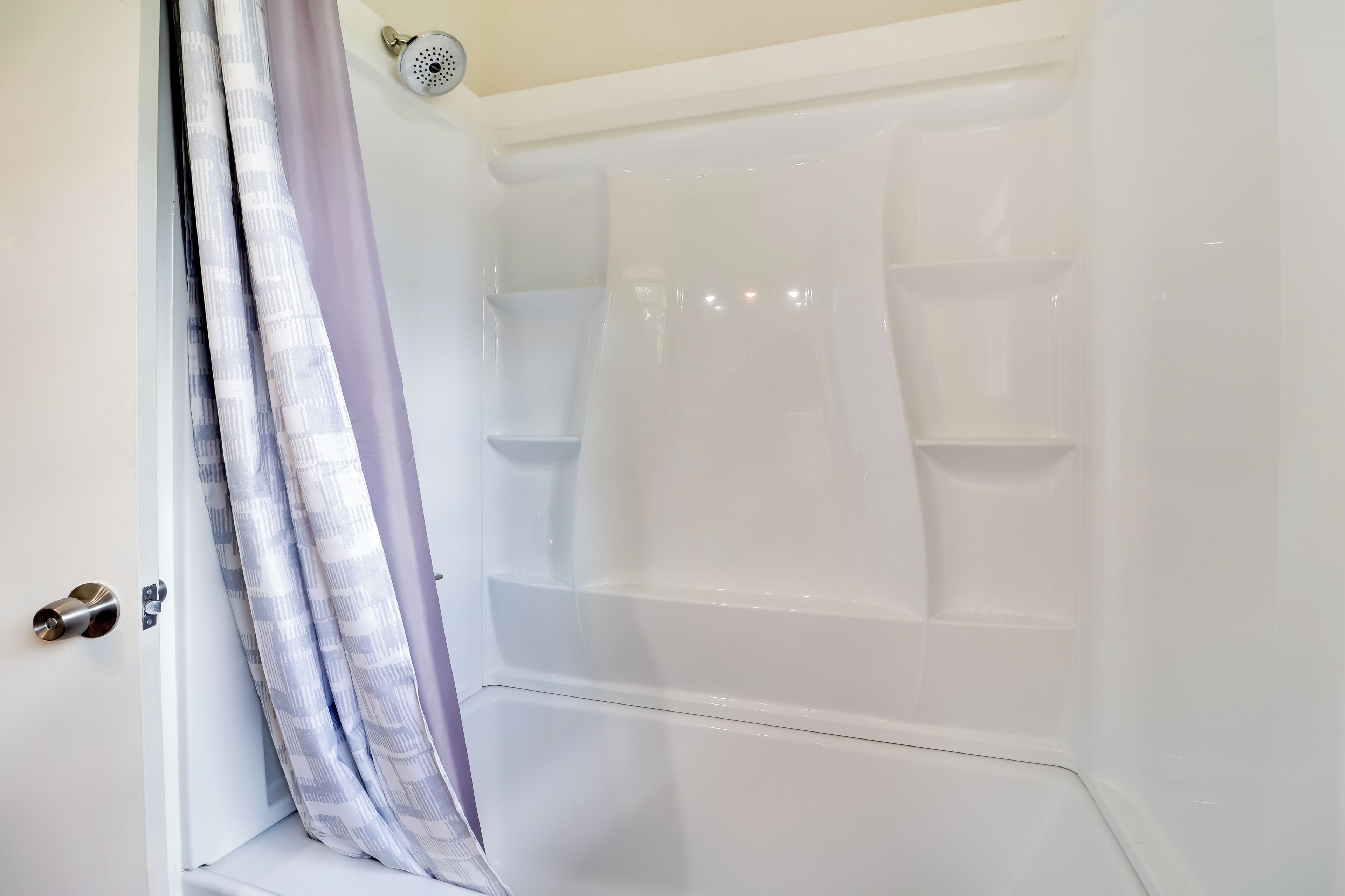 A bathroom with a shower, a toilet, and a sink.