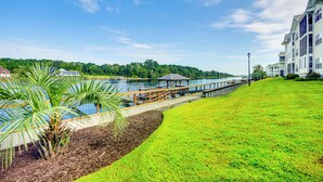 A waterfront property with a wooden dock, a gazebo, and a grassy area. - 2 Mi to Beach: Grand Strand Condo w/ Pool Access! (North Myrtle Beach)