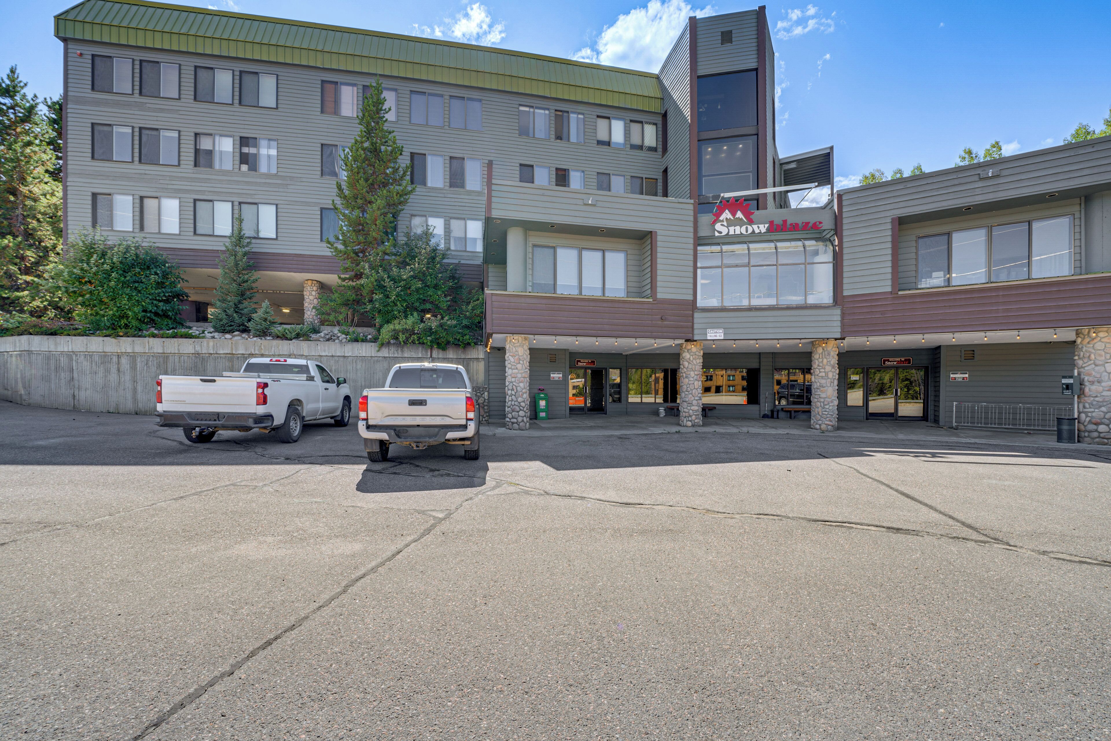 A multi-story building with a storefront labeled "Sno White".