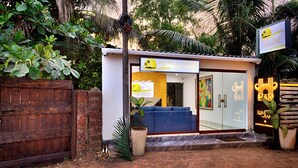 A small beachside building with a sign reading "Royale Amata by the Beach". - Royale Amata By the Beach (Morjim)