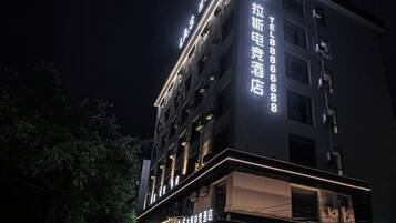 A multi-story hotel building with illuminated signage and a prominent entrance.