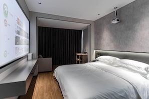 A modern hotel room with a large bed, a desk, and a wall-mounted projector. - Las Electronics Competition Hotel (Liushi Branch) (Yueqing)