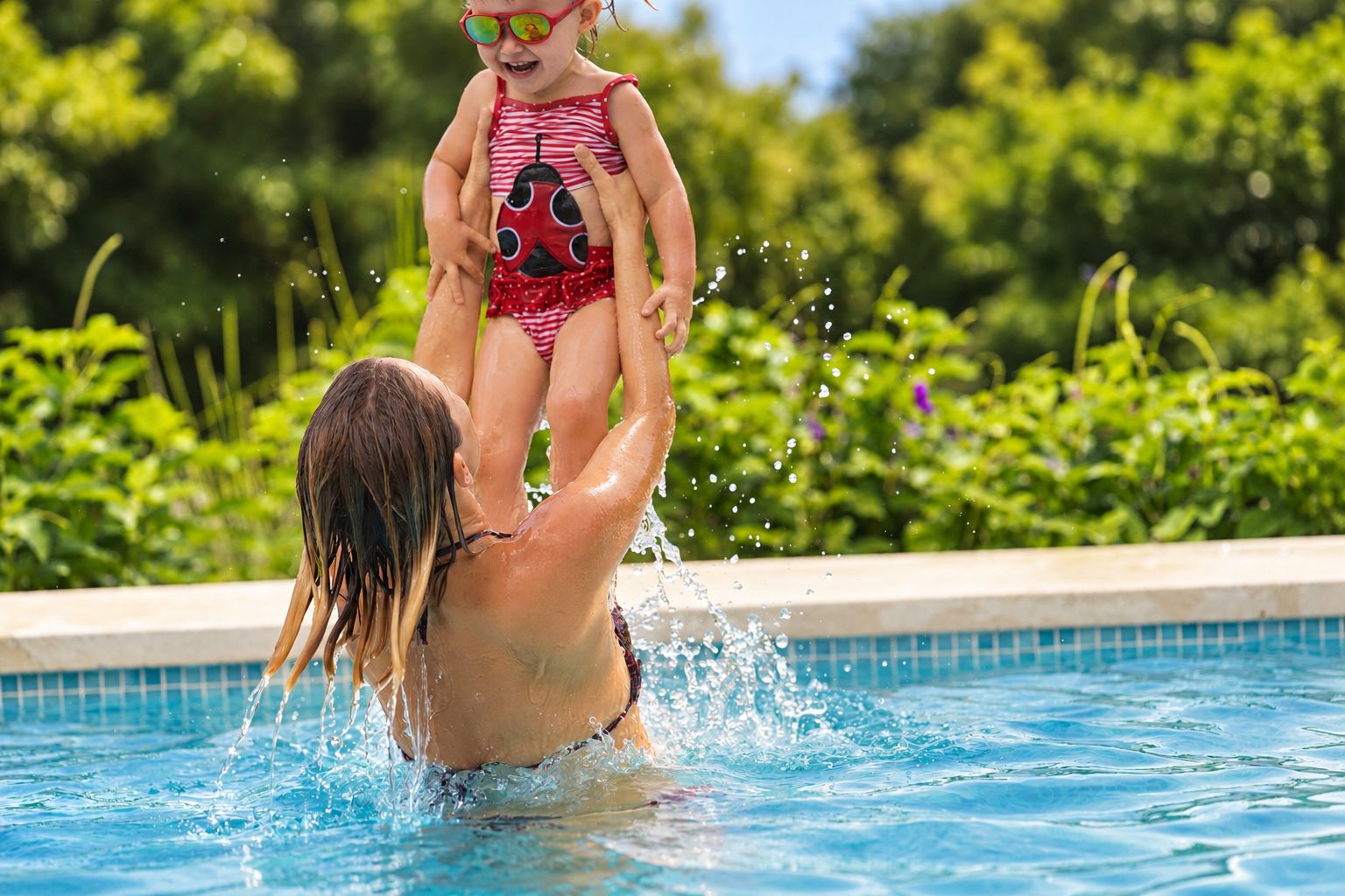 A person in a swimming pool with water splashing around.