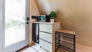 A compact kitchen with a built-in microwave, a small refrigerator, and a potted plant on a wooden shelf. - New A-Frame Tiny Home Retreat -With Private Sauna! (Christiana)