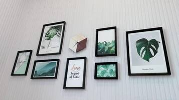 A wall with seven framed botanical prints arranged in a row.