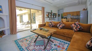 A modern living room with a sofa, coffee table, and patterned rug.