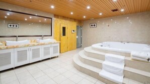 A modern bathroom with a wooden ceiling, a large mirror, a bathtub, and a vanity with sinks. - Yijia Hotel (Wuding)