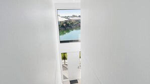 A modern interior with a view of a lake and buildings. - 4-13 Central Dr Victor Harbor - Wi-Fi and Linen (Victor Harbor)