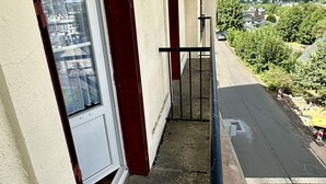 A balcony with a view of a mountain and a road.