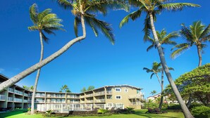 A multi-story hotel with balconies, a swimming pool, and palm trees. - Privacy, Ocean View! Modern Kitchen, WiFi, Flat Screen, Lanai–Kauai Kailani K212 (Kapa'a)