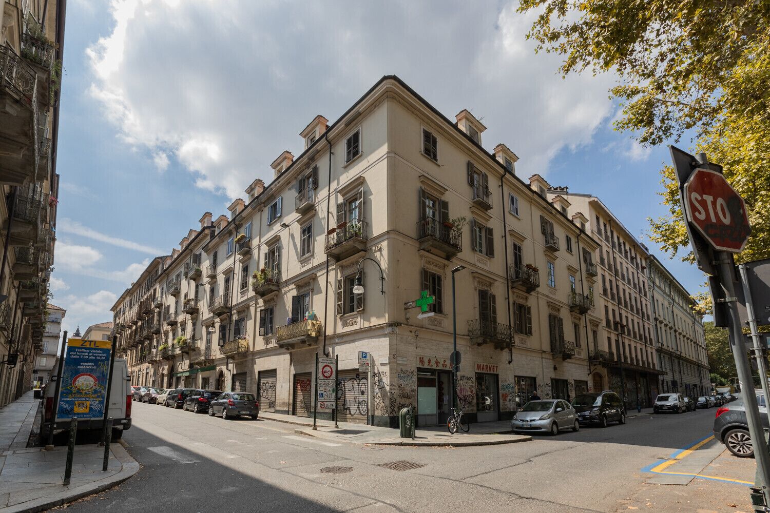 A multi-story building with a ground-floor market and a pharmacy.