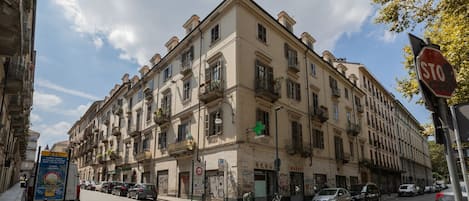 A multi-story building with a ground-floor market and a pharmacy.