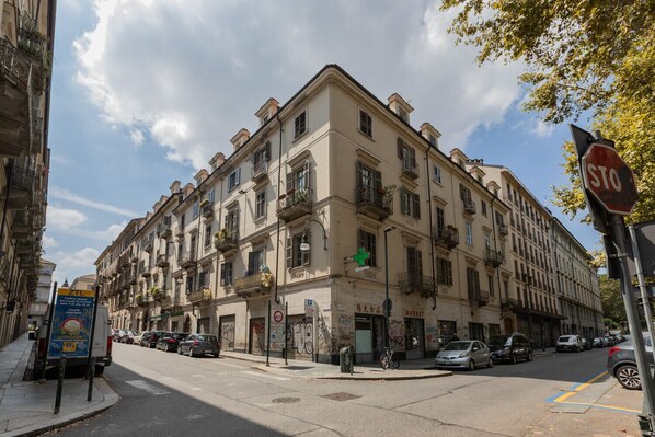 A multi-story building with a ground-floor market and a pharmacy.
