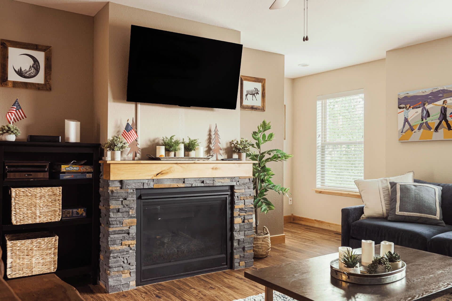 A living room with a fireplace, television, and a couch.