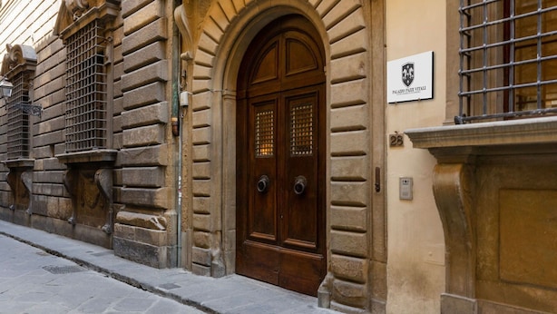 A historic building with a prominent arched entrance, a plaque indicating 'Palazzo Pazi Vitai', and a number '28' on the wall. - Pazzi Penthouse By Geco Vacation Rentals (Florence)