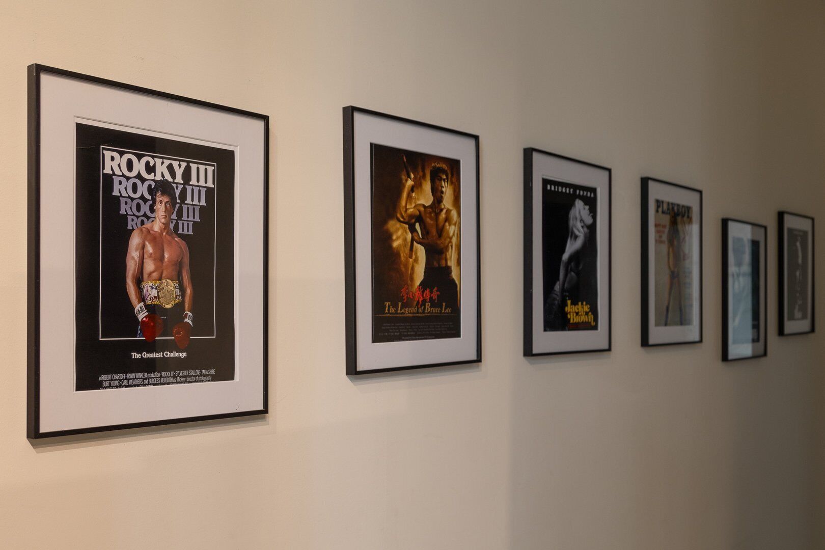 A series of framed movie posters on a wall.