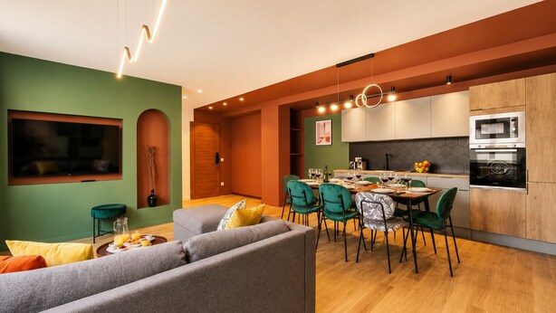 A modern kitchen with a dining area, a sofa, and a TV. - TBS 88 - Elegant and modern apartment in Paris (Paris)