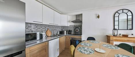 Microwave, dishwasher, coffee/tea maker, dining tables