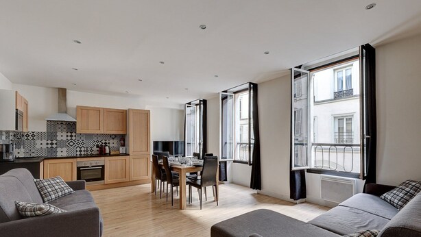A modern apartment with a dining area, kitchen, and seating space. - TBS 161 - Spacious apartment in the heart of Paris (Paris)