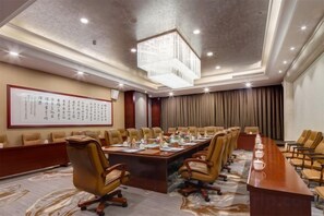 A conference room with a long table, chairs, and a chandelier. - Hongteng International Hotel (Jinan)
