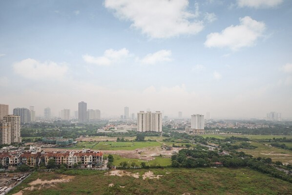 A cityscape with high-rise buildings, a mix of residential and commercial structures, and green spaces. - Vinhomes Green Bay Luxury Apartment  (Hanoi)