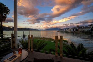A terrace with a view of a lake and mountains at sunset. - Dali Guqinhai Sea Viewing Inn (Dali City)