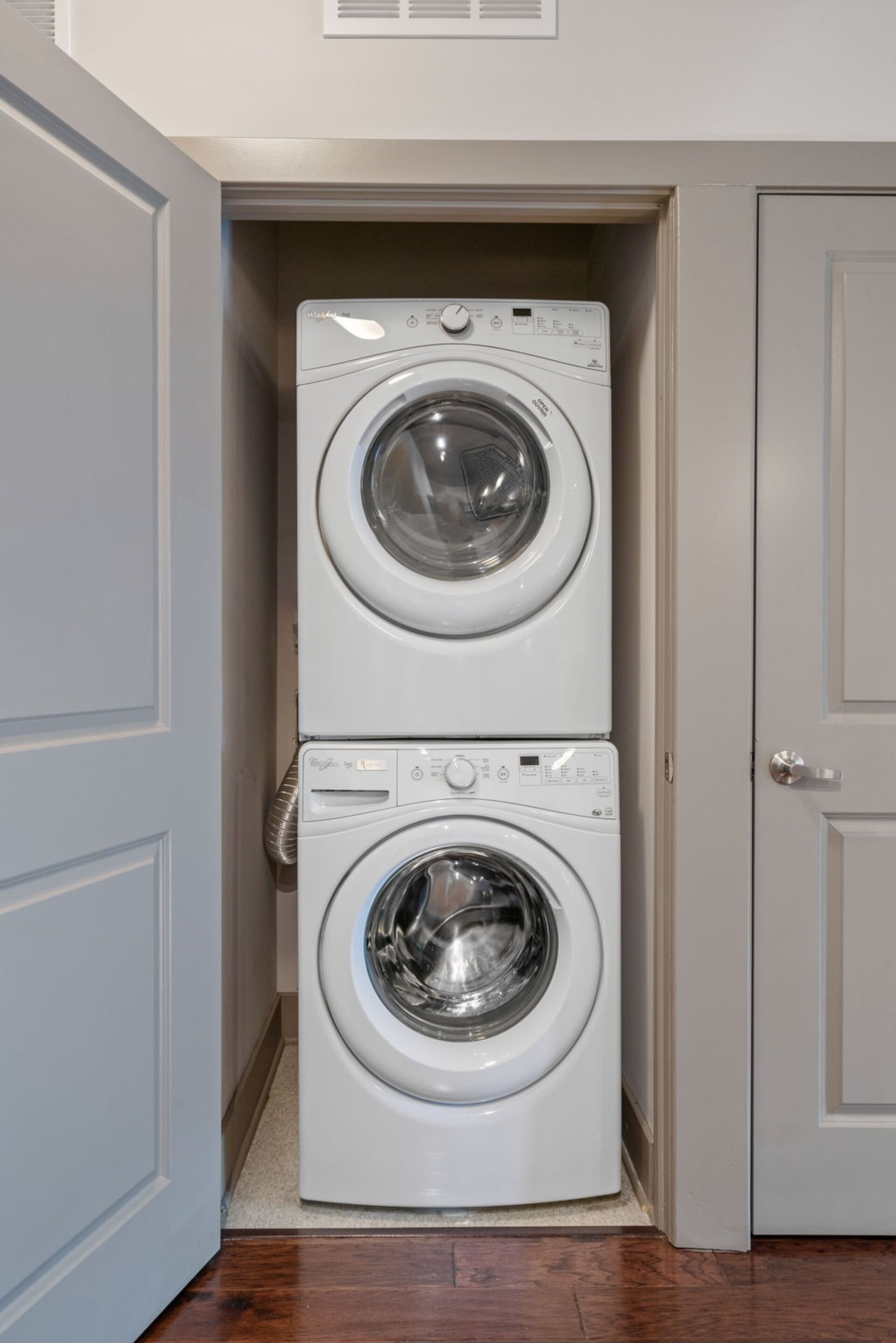 A laundry room with two stacked front-loading washing machines.