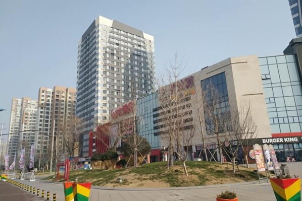 A modern urban area with high-rise buildings, a Burger King restaurant, and a pedestrian walkway. - Jiaozhou Haiyue Apartment Hotel (Jiaozhou)