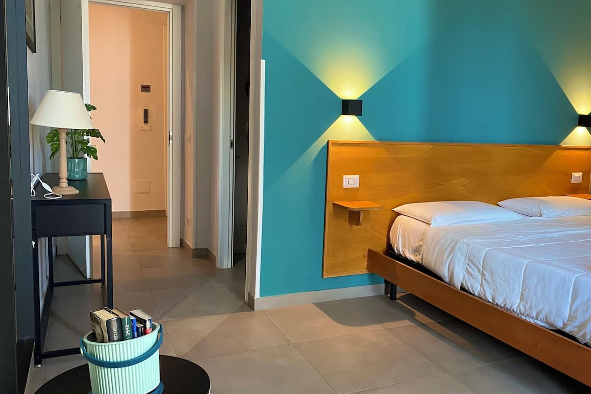 Deluxe Quadruple Room, Balcony, City View | Hypo-allergenic bedding, minibar, desk, laptop workspace