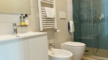 Deluxe Quadruple Room, Balcony, City View | Bathroom | Shower, hair dryer, towels, soap