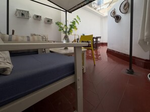 A dormitory room with a bunk bed, a small table, a yellow chair, and a potted plant. - Spacious Apartment, Seneca 1A next to the Center. (Málaga)
