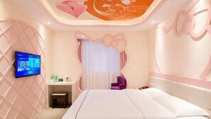 A modern bedroom with a large bed, a television, a desk, and a chair. - Fubang Hotel (Yichun)