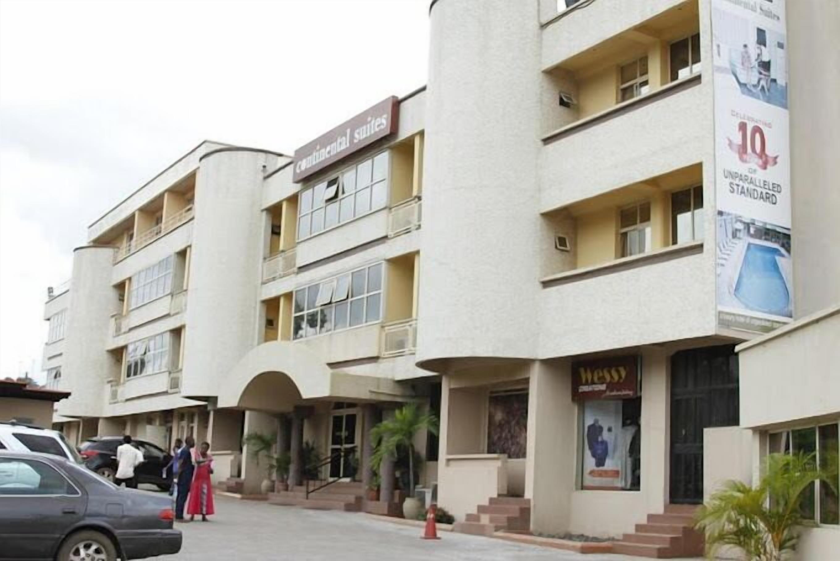 A multi-story hotel with a sign for continental suites.