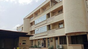 A multi-story building with a flat roof, large windows, and a central entrance. - Continental Suites Ltd (Abeokuta)