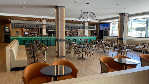 A modern bar area with seating and a bar counter. - Hotel Onyx (Belgrade)