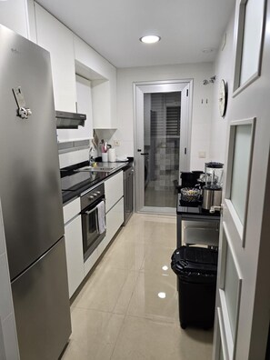 Classic Quadruple Room, City View | Private kitchen | Oven, cookware/dishes/utensils