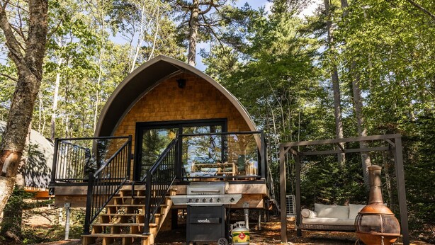 A cabin with a wooden exterior, a balcony, and a grill area. - Sunken Escapes Kenny's (Unit 5) (Sunken Lake)