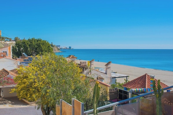 A coastal view with a beach, buildings, and a clear sky. - Lovely apartment 50m from the beach! (Fuengirola)