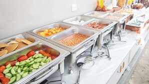 A buffet with various food items including fruits, vegetables, and meats. - Palm Oasis at Ukulhas (Ukulhas)