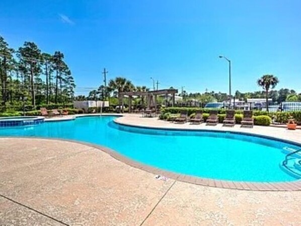 A swimming pool with lounge chairs and a gazebo. - Water Views! Pool & hot tub - 2be/2ba condo in Ocean Springs! Harbor Landing (Ocean Springs)
