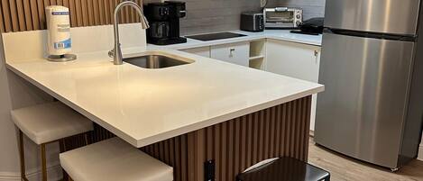 Een microgolfoven, een kookplaat, een vaatwasser, een broodrooster